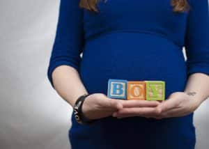 Mom holding blocks that spell out BOY